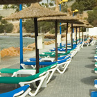 Loungers at Cabo Roig beachfront.